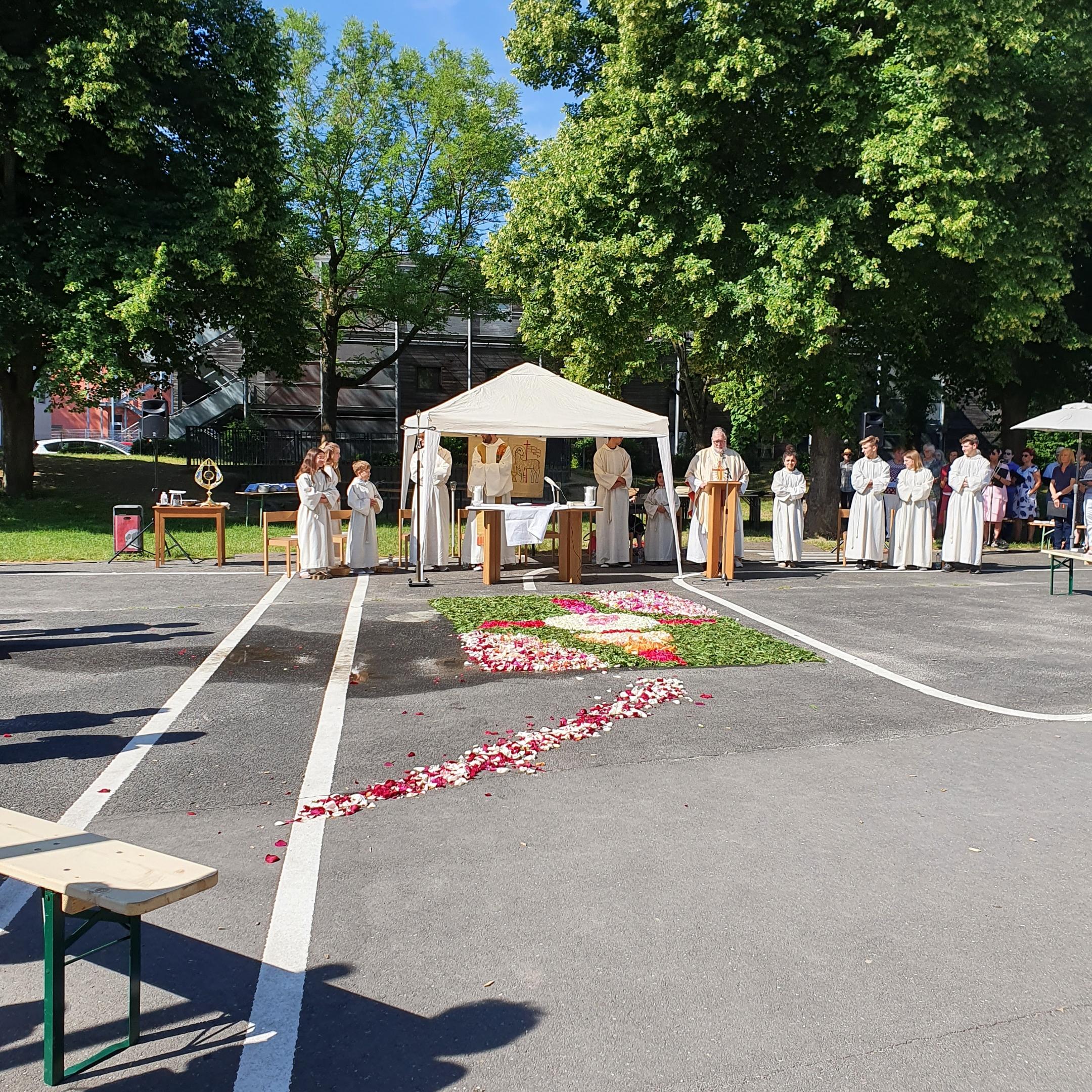 im Vordergrund der Schulhof vor der Kirche, im Hintergrund das Zelt