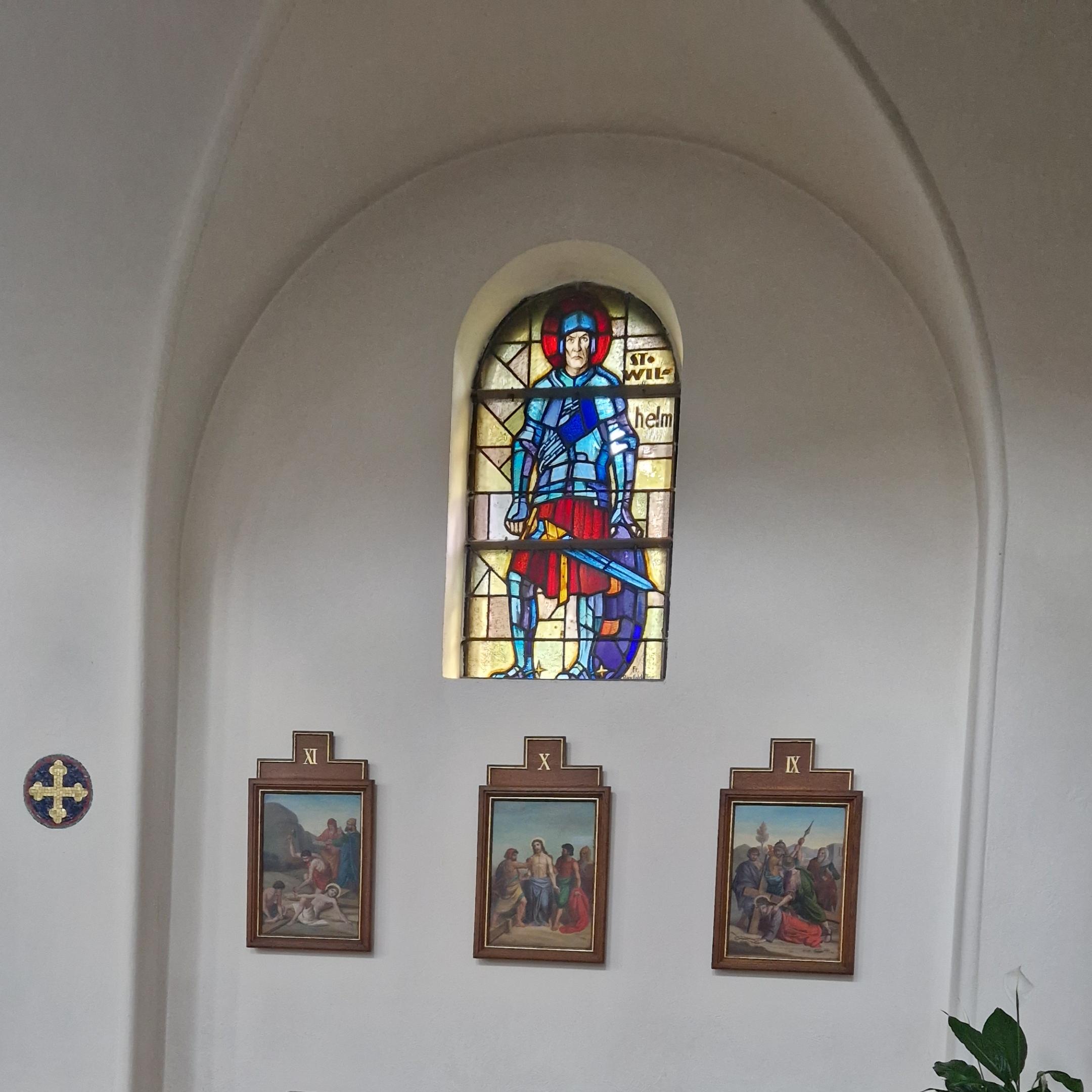 Teilausschnitt aus dem Innenraum der Kirche St. Martinus, im Fokus steht das Kirchenfenster, das den Heiligen Wilhelm darstellt